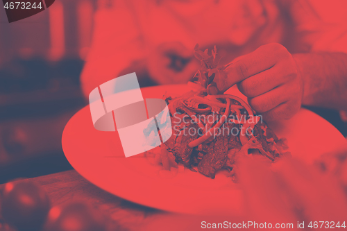 Image of cook chef decorating garnishing prepared meal