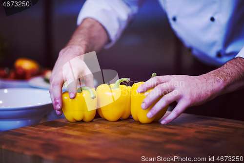 Image of chef holding fresh peppers