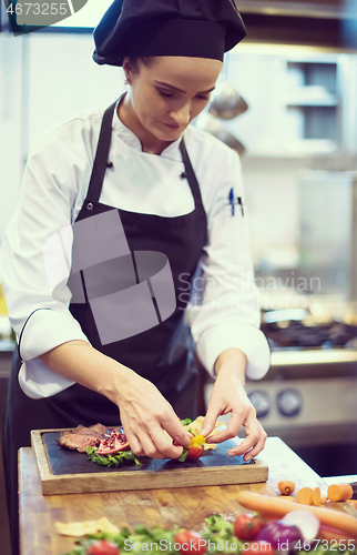 Image of female Chef preparing beef steak