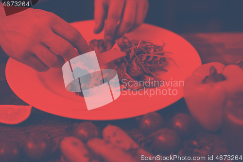 Image of chef serving vegetable salad