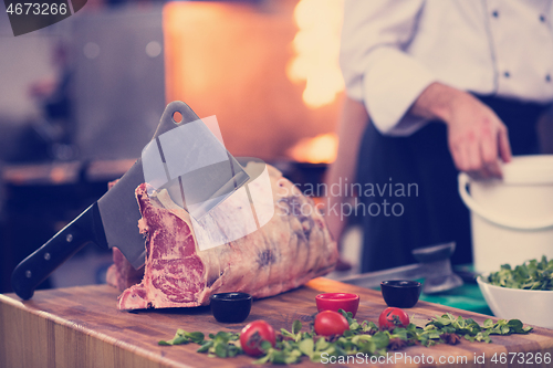 Image of chef cutting big piece of beef