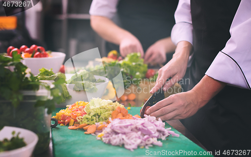 Image of team cooks and chefs preparing meals