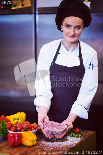 Image of Chef holding juicy slice of raw steak