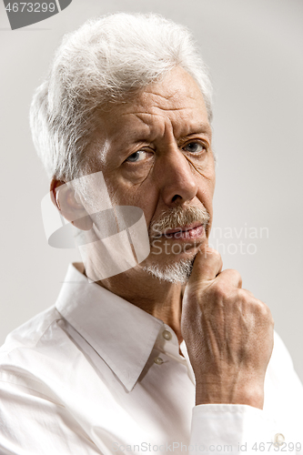 Image of The serious businessman against gray background.