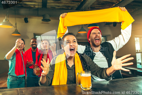 Image of Sport, people, leisure, friendship and entertainment concept - happy football fans or male friends drinking beer and celebrating victory at bar or pub