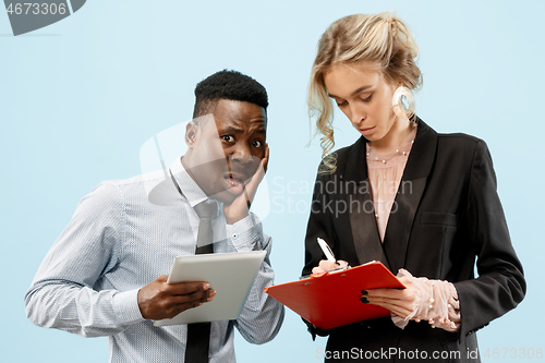 Image of Serious businesswoman and colleague in the office.