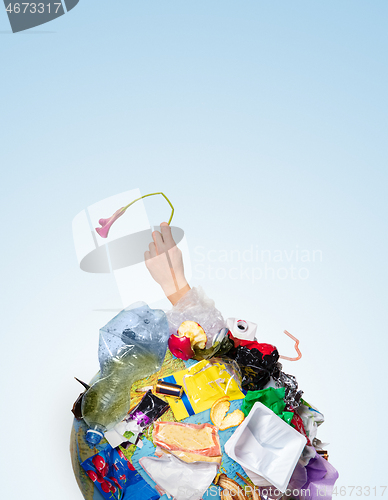 Image of A globe of the earth with trash over white background, the concept of ecology problem