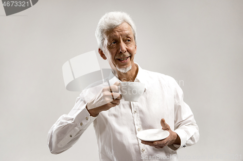 Image of old age, drink and people concept - happy senior man with cup of tea at home
