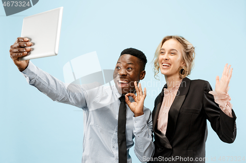 Image of Concept of partnership in business. Young man and woman standing at studio