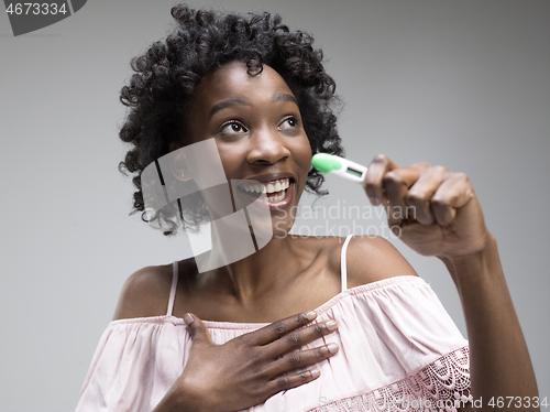 Image of Smiling young woman looking on pregnancy test