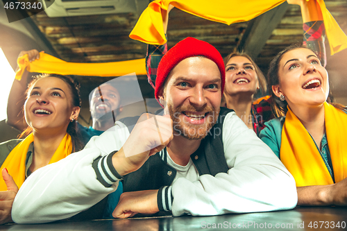 Image of Sport, people, leisure, friendship and entertainment concept - happy football fans or male friends drinking beer and celebrating victory at bar or pub