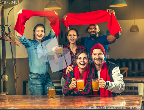 Image of Sport, people, leisure, friendship and entertainment concept - happy football fans or male friends drinking beer and celebrating victory at bar or pub