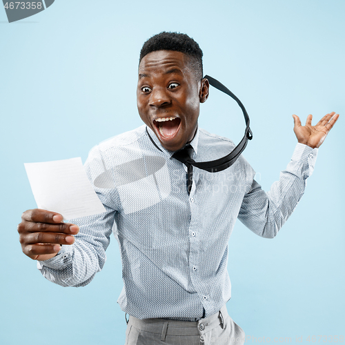 Image of Young boy with a surprised expression won a bet on blue background