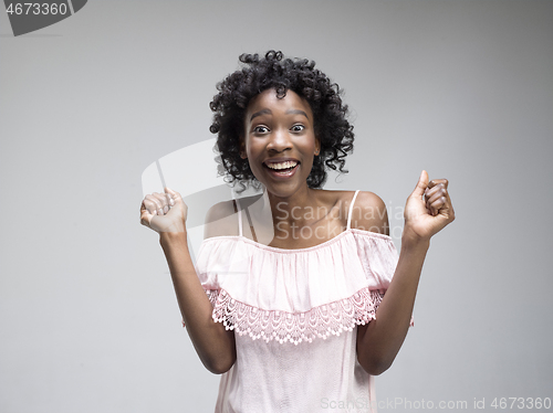 Image of Winning success woman happy ecstatic celebrating being a winner. Dynamic energetic image of female afro model