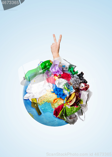 Image of A globe of the earth with trash over white background, the concept of ecology problem