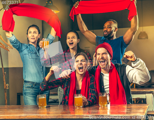 Image of Sport, people, leisure, friendship and entertainment concept - happy football fans or male friends drinking beer and celebrating victory at bar or pub