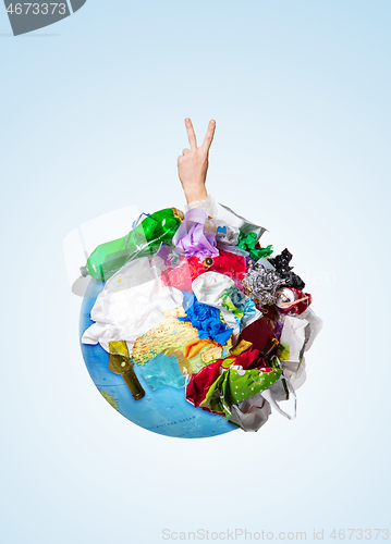 Image of A globe of the earth with trash over white background, the concept of ecology problem