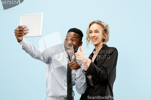 Image of Concept of partnership in business. Young man and woman standing at studio