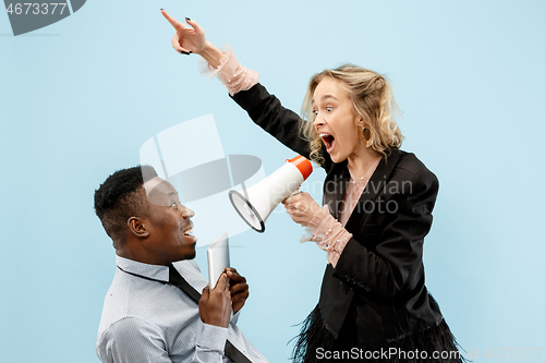 Image of angry businesswoman and colleague in the office.