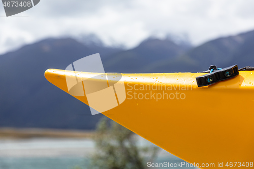 Image of the head of an orange canoe at the lake in New Zealand