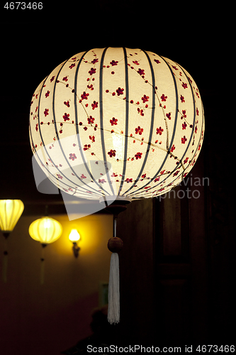 Image of White Chinese lantern over black background