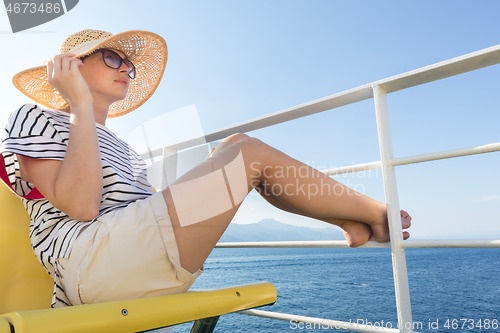 Image of Beautiful, romantic blonde woman taking selfie self portrait photo on summer vacations traveling by cruse ship ferry boat.