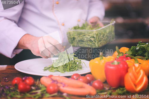 Image of chef serving vegetable salad