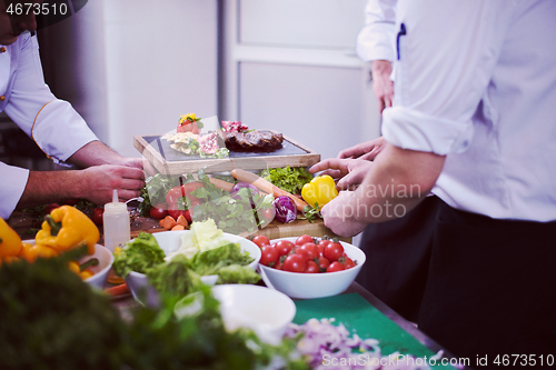 Image of team cooks and chefs preparing meal