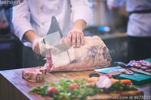 Image of chef cutting big piece of beef