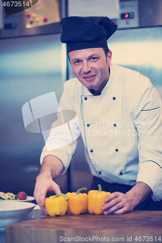 Image of chef holding fresh peppers