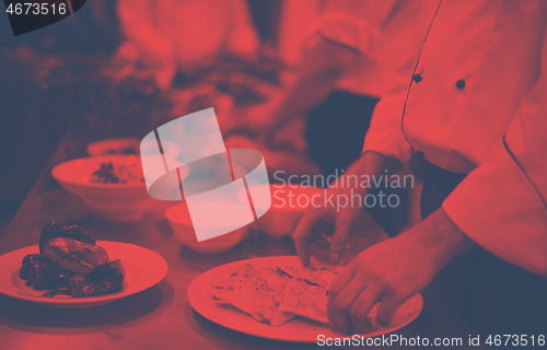 Image of team cooks and chefs preparing meal