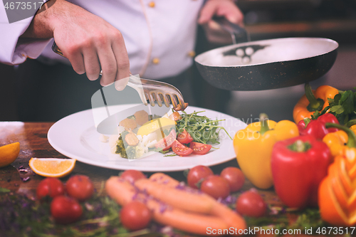 Image of chef serving vegetable salad