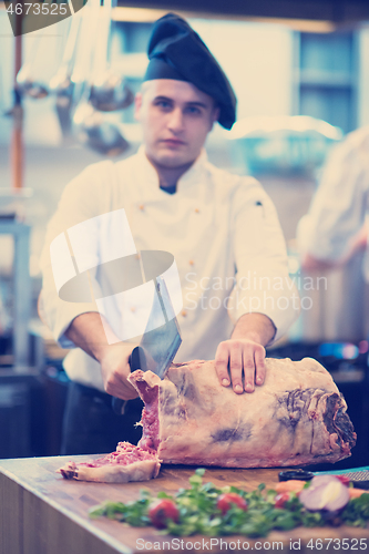 Image of chef cutting big piece of beef