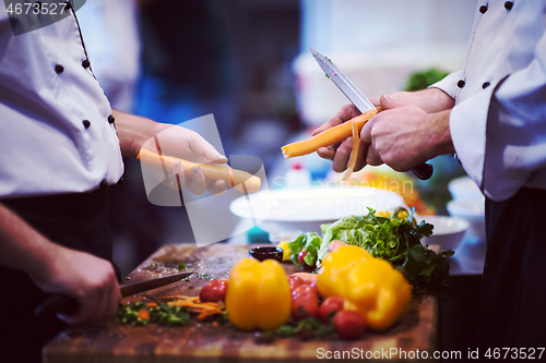 Image of chefs hands cutting carrots