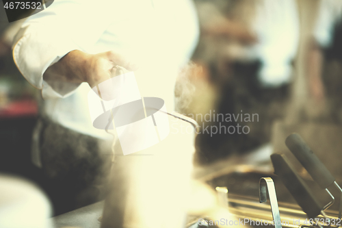 Image of chef preparing food, frying in deep fryer