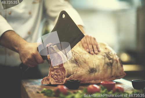 Image of chef cutting big piece of beef