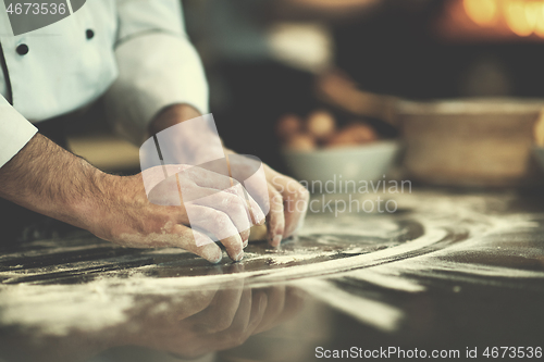 Image of chef hands preparing dough for pizza