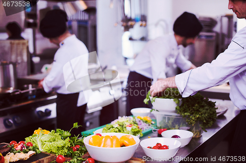 Image of team cooks and chefs preparing meals