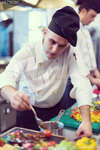 Image of Chef finishing steak meat plate