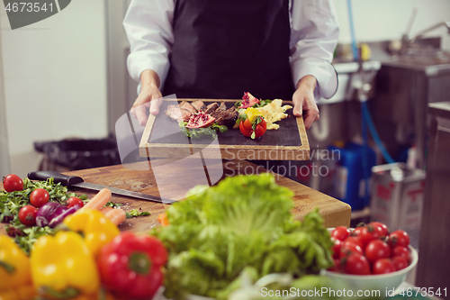 Image of female Chef holding beef steak plate