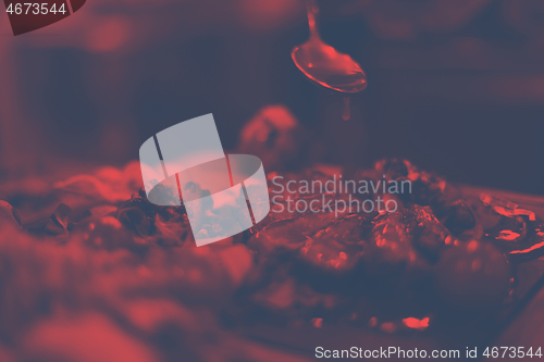 Image of Chef hand finishing steak meat plate