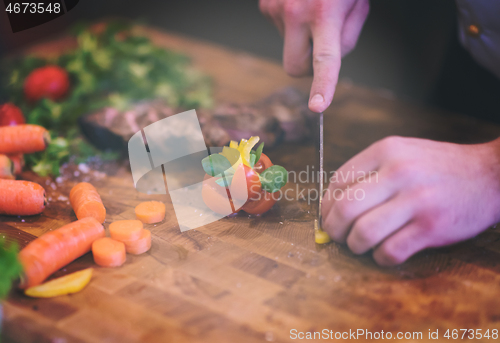 Image of closeup of Chef hands preparing beef steak