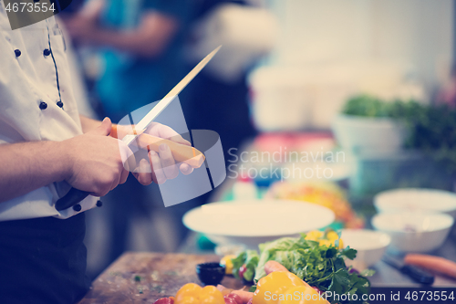 Image of chef hands cutting carrots