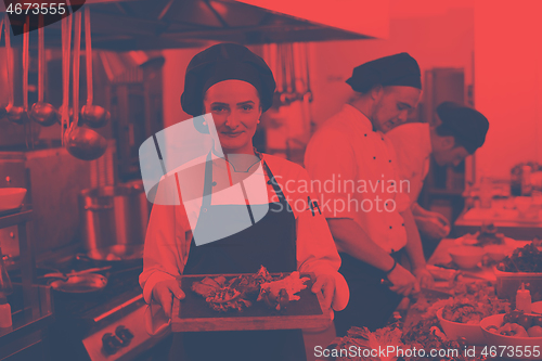 Image of female Chef holding beef steak plate