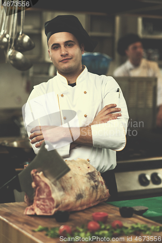 Image of chef cutting big piece of beef