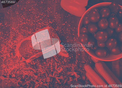 Image of top view of raw steak on wooden table