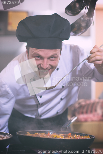 Image of chef tasting food with spoon