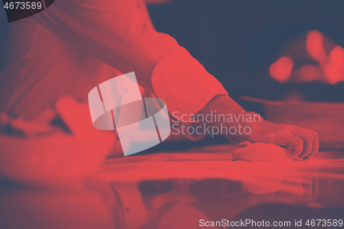 Image of chef hands preparing dough for pizza