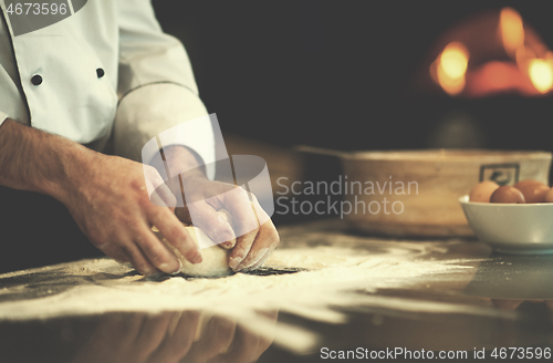 Image of chef hands preparing dough for pizza