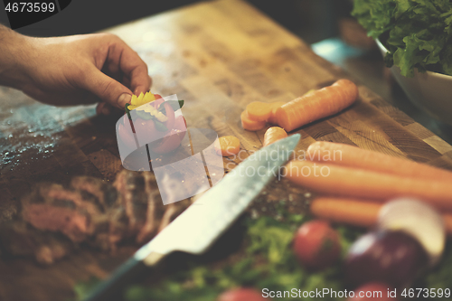 Image of closeup of Chef hands preparing beef steak